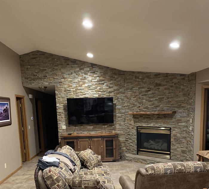 A stone feature wall and fireplace by Mid-State Tile Company