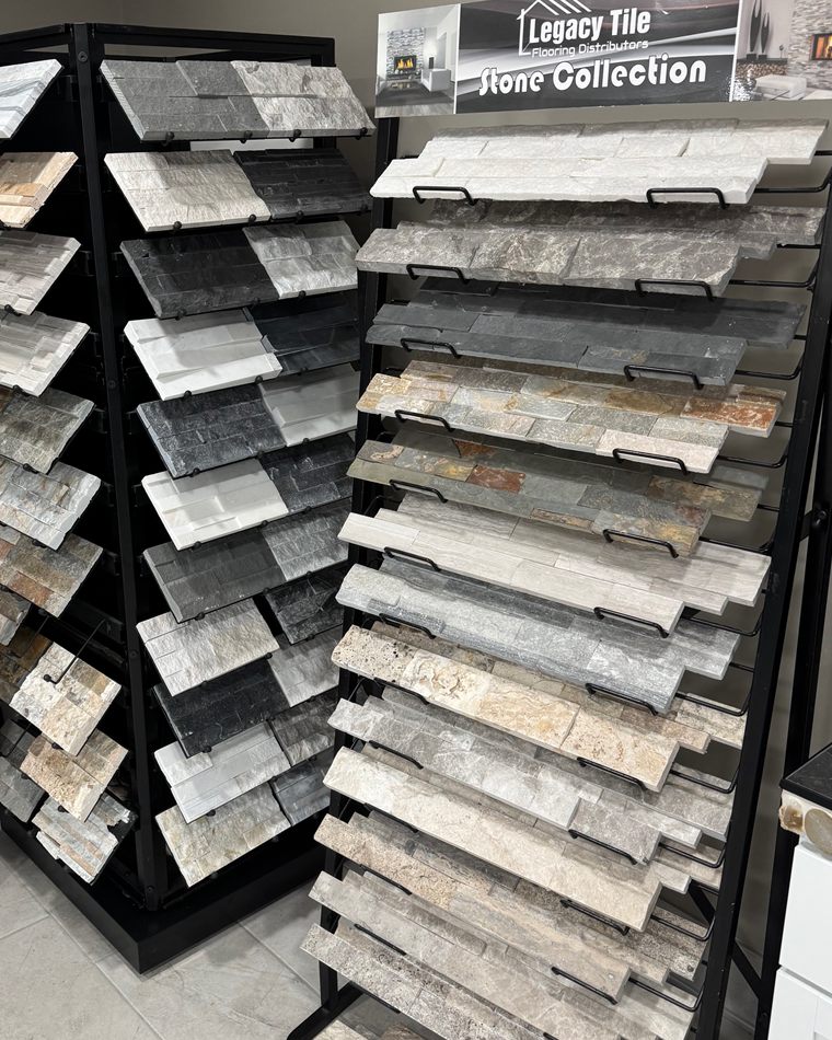 Showroom racks of stacked stone ledger panels in white quartz, gray, black slate and rust tones